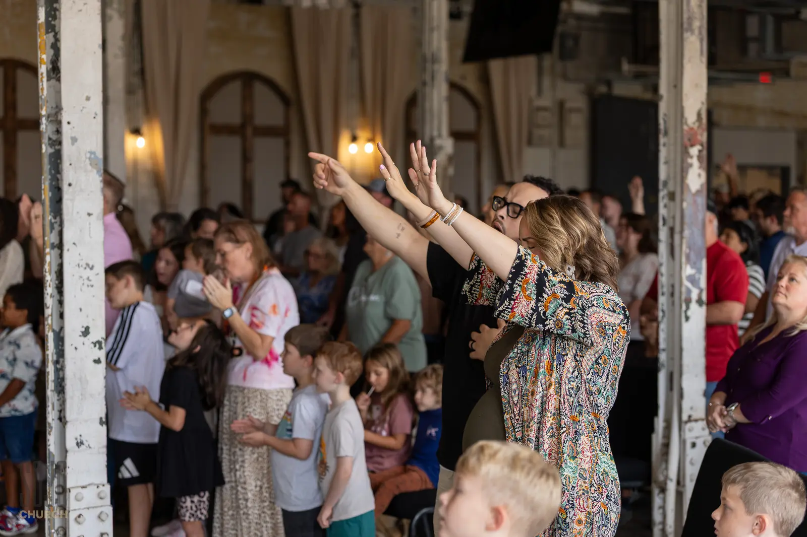 The SOJO congregation worshipping among the original mill columns at the Kettle Room