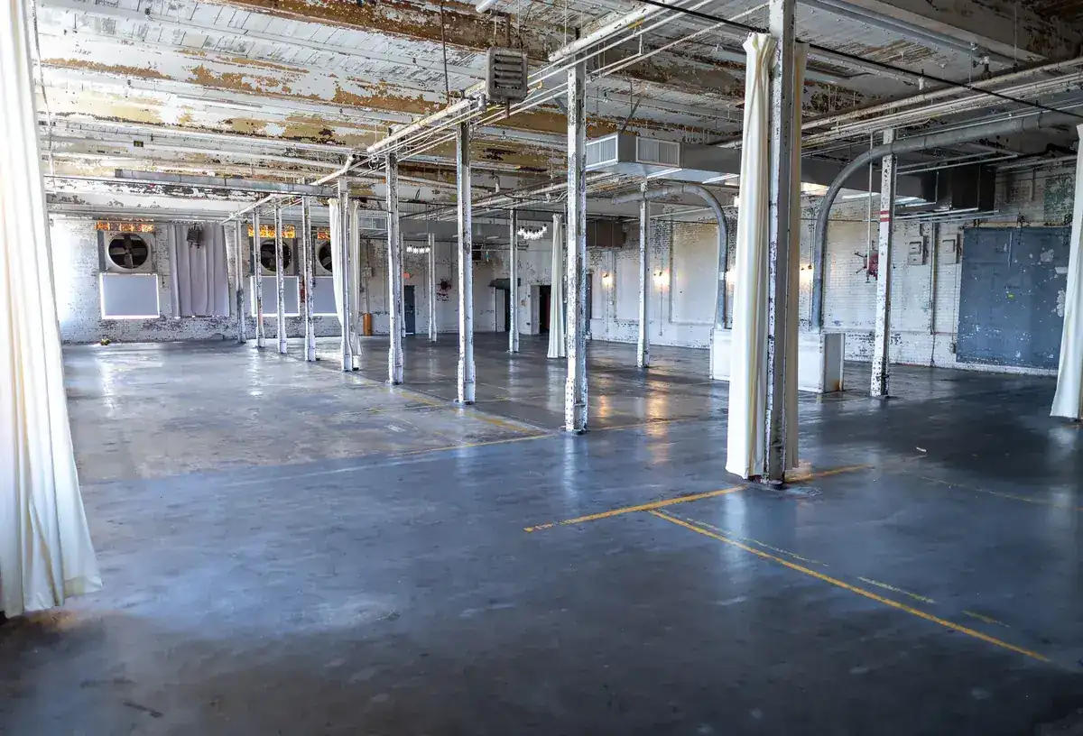 Rows of steel columns down the mill floor, August 2026